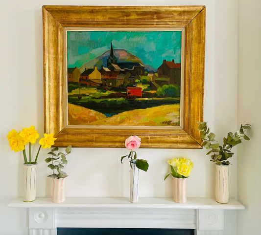 4 large golden framed oil painting sat on the mantel behind a collection of hand crafted ceramic vases