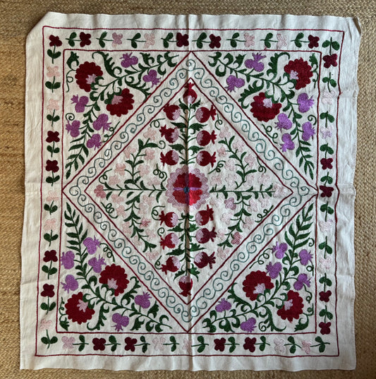 Pretty pink, red and green small Suzani, corner detail