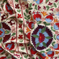 Bold multicoloured large Suzani fabric, close-up view